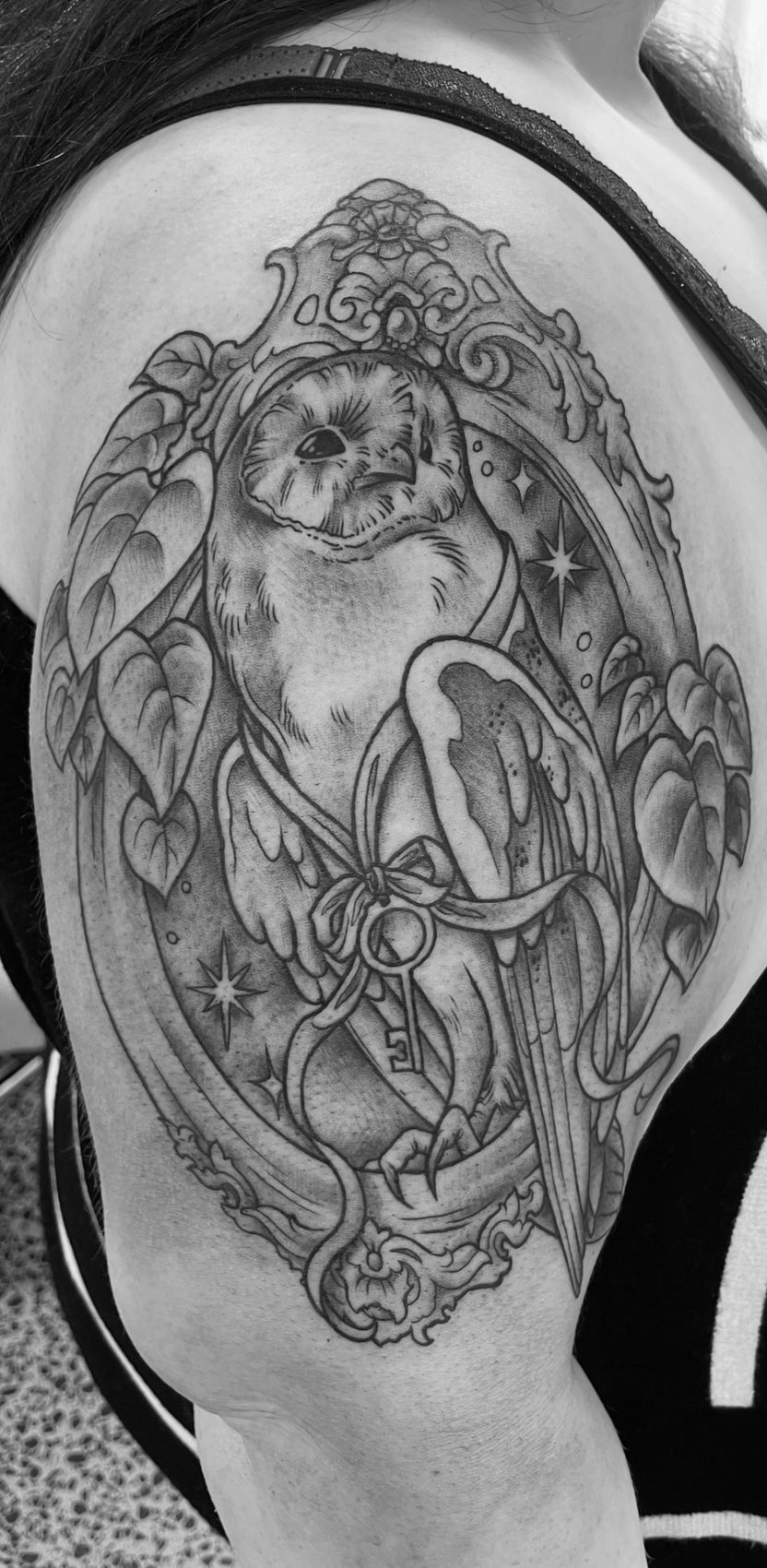 Black and grey ornamental figure tattoo